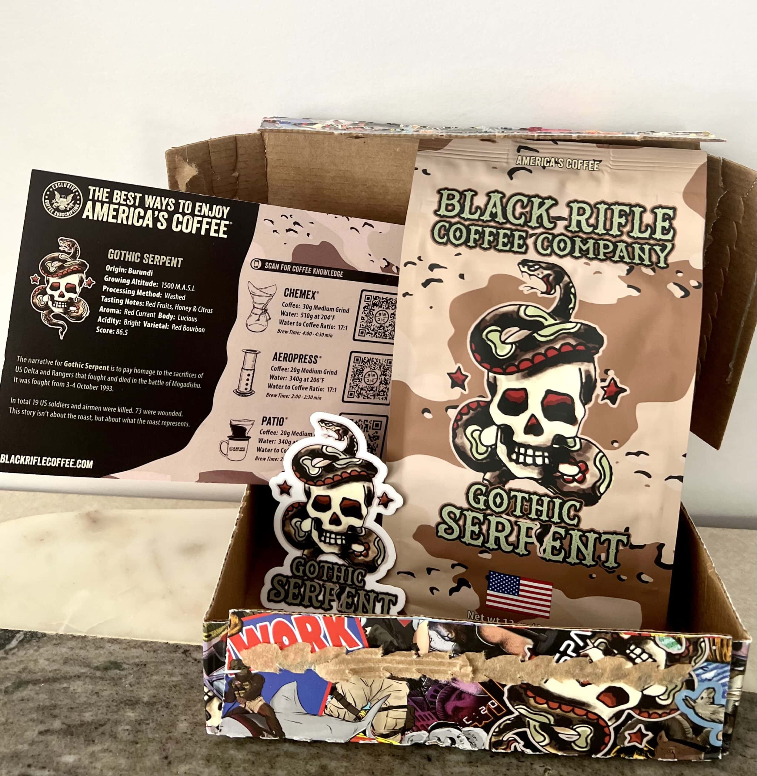Black Rifle Coffee - opened Exclusive Coffee Subscription box with a pack of coffee, postcard and sticker