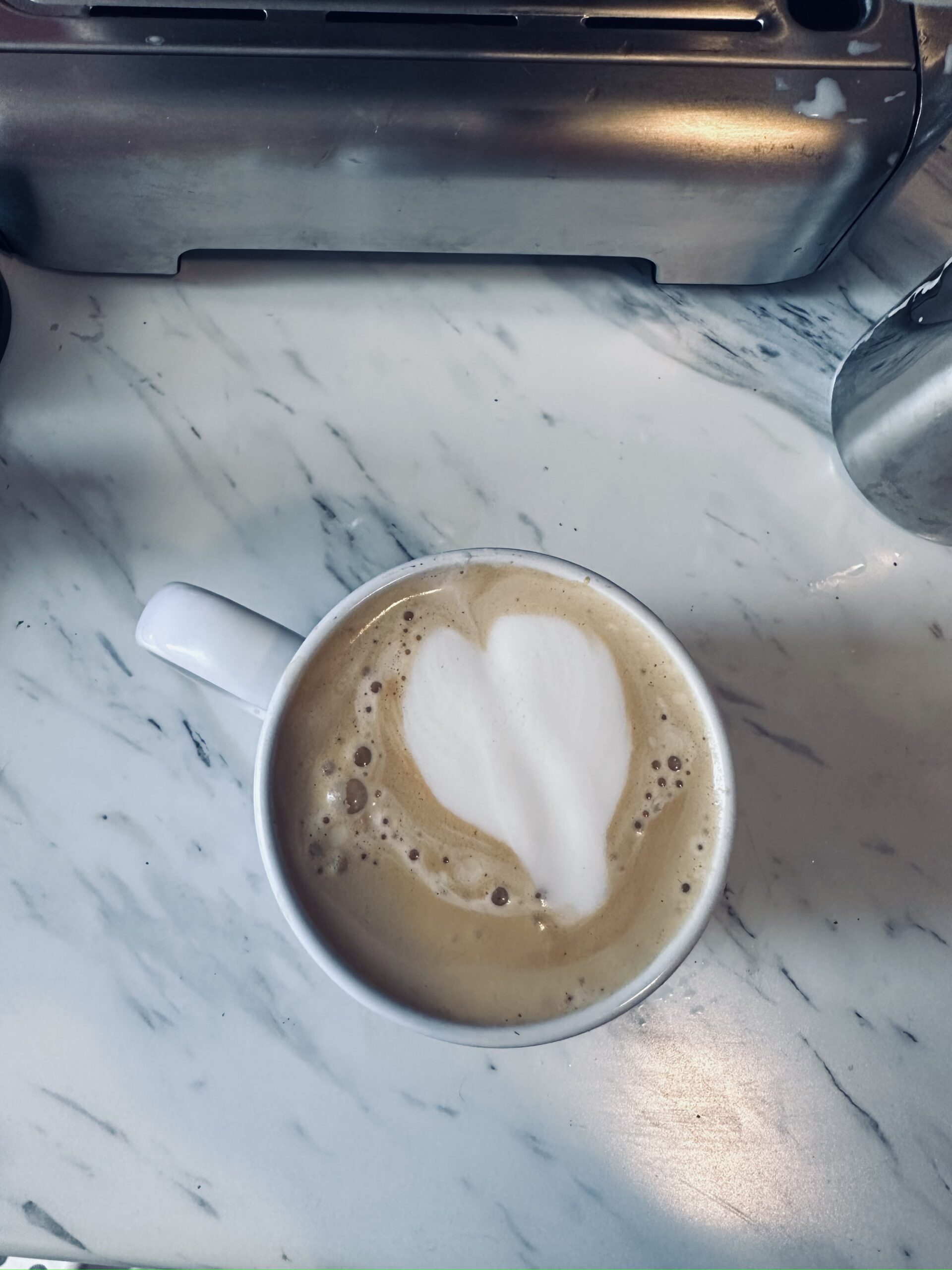 cup of coffee with milk heart prepared by Casabrews Espresso Machine