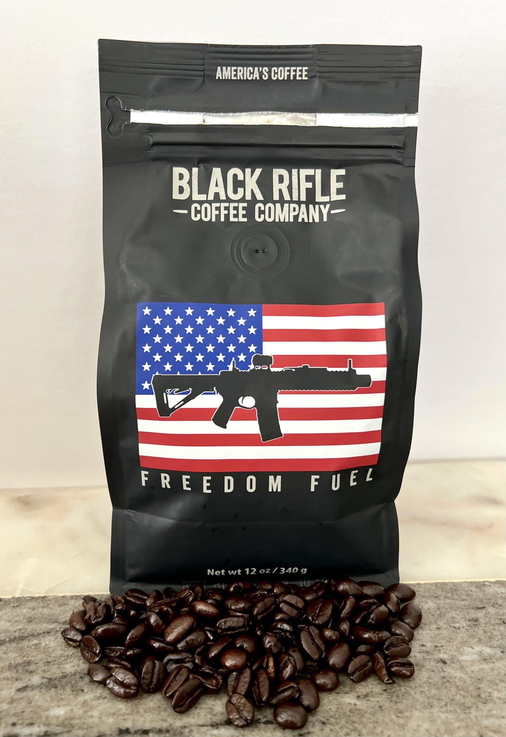 Freedom Fuel - Black Rifle Coffee near scattered coffee beans