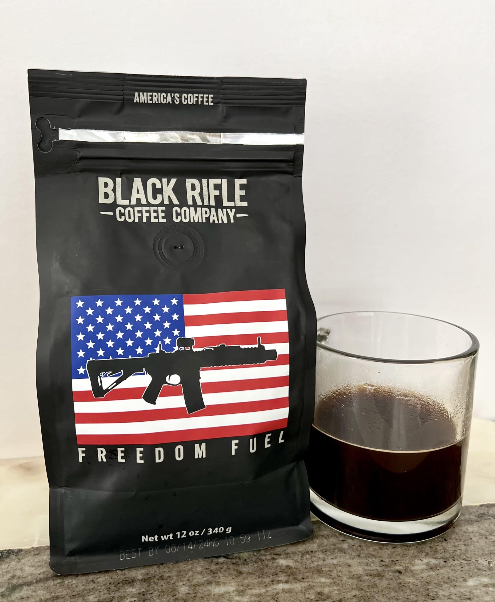 Freedom Fuel - Black Rifle Coffee next to the mug with brewed coffee