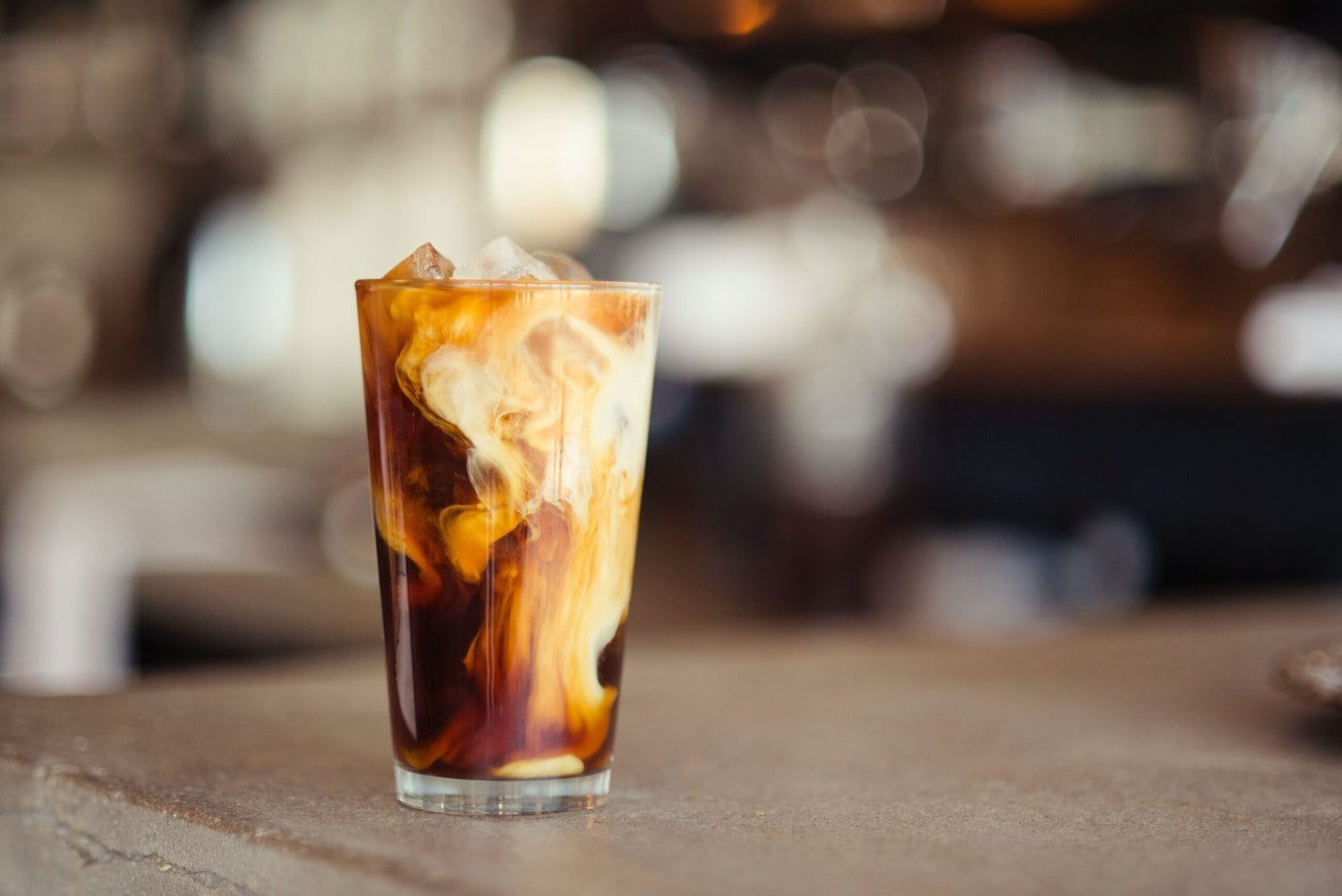 glass cup filled with Iced milk and chocolate drink on the tabletop