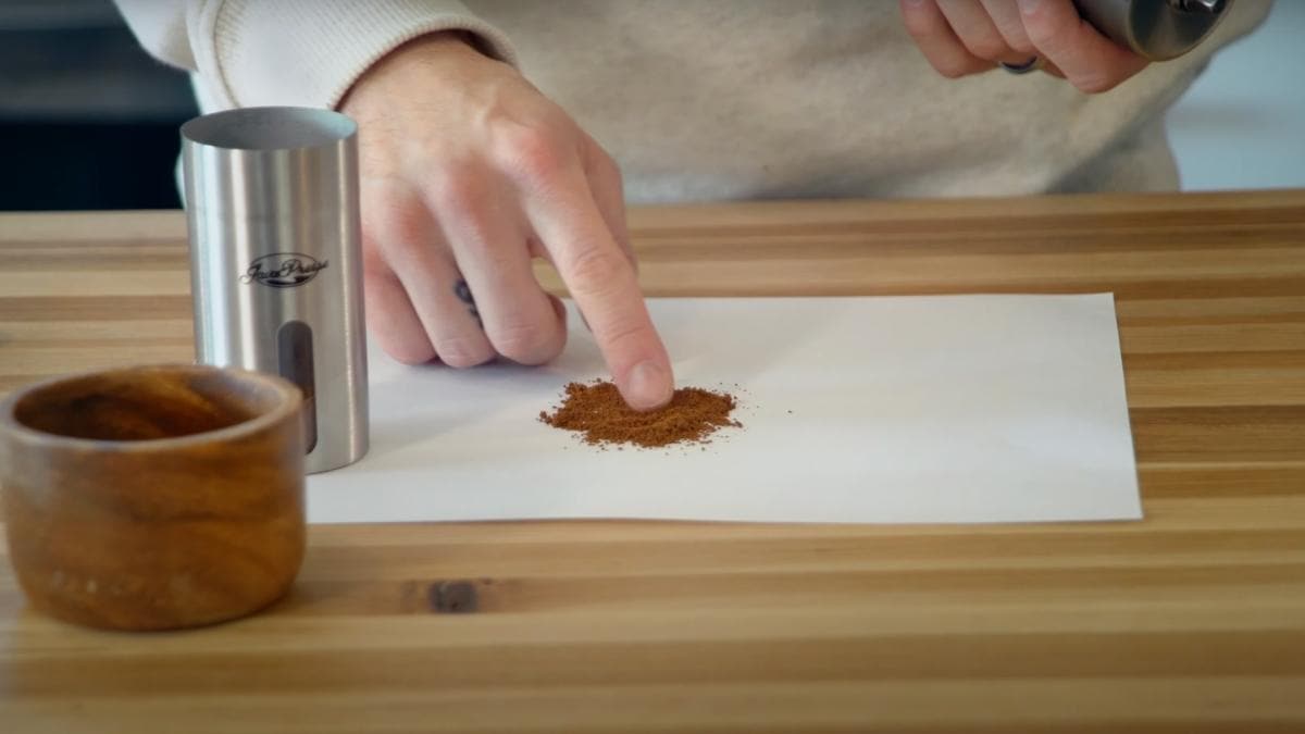 ground coffee from a grinder on a piece of paper