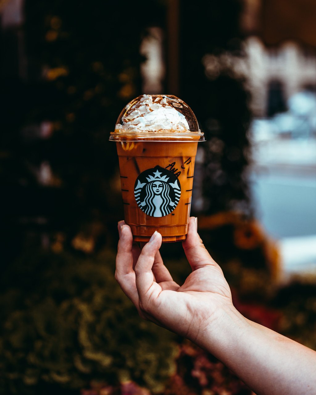 woman holding Starbucks Iced Latte in her hand